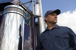 Image of older long haul trucker and his truck